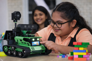 an autistic girl is learning from the robot